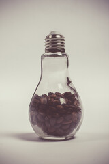 Light bulb with coffee beans, bottle with coffee beans