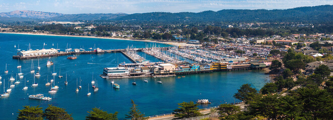 Beautiful aerial view of the Monterey town in California with many yachts docked by the pier.