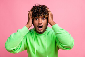 Portrait of confused young guy staring hands touch open mouth when see inflation and high prices isolated on pink color background - obrazy, fototapety, plakaty