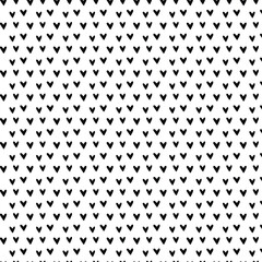 Hand-drawn doodle seamless pattern with hearts. Black and white. Cute Hand-drawn nursery cartoon doodle. Black shapes on a white background. Perfect for printing fabrics, packaging, clothes 