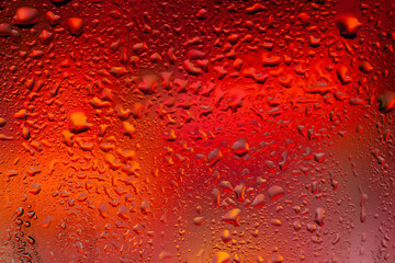 Water drops on glass. Drops of rain on the window. Abstract background. Colorful spots. Texture of drops