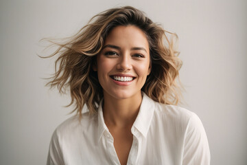 A joyful woman in a white shirt, isolated on a white background