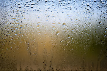 Drops of rain on the window. Water drops on glass. Abstract background. Green natural landscape....