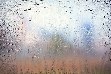 Raindrops on the window. Water drops on glass. Abstract background. Cityscape. Texture of drops. Selective focus