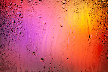 Drops of rain on the window. Water drops on glass. Abstract background. Colorful spots. Texture of drops. Selective focus