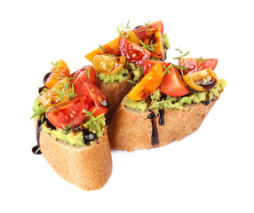 Delicious bruschettas with avocado, tomatoes and balsamic vinegar isolated on white