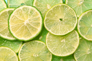 Slices of fresh lime as background, closeup