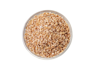 Dry wheat groats in bowl isolated on white, top view