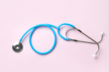 Modern stethoscope on  pink background
