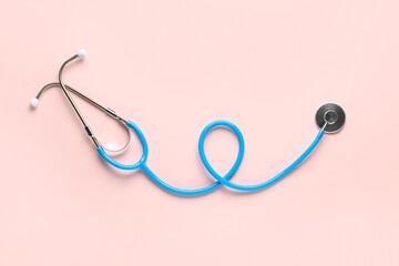 Modern stethoscope on pink  background