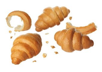 Delicious fresh croissants falling on white background
