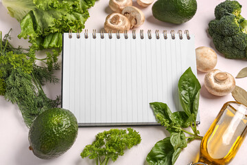 Composition with blank recipe book, fresh vegetables and herbs on light background