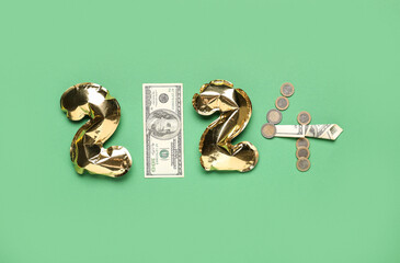 Figure 2024 made of foil balloons and money on color background