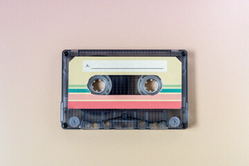Obraz premium Top view of a music cassette on a yellow background.