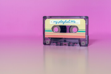 Transparent audio cassette with my playlist label on fuchsia background.