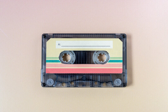 Top view of a music cassette on a yellow background.