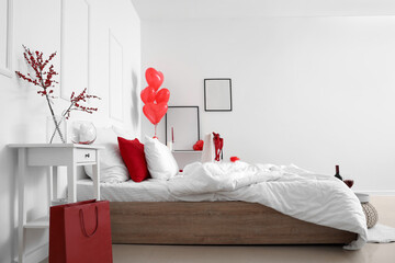 Interior of light bedroom with heart-shaped balloons and red lingerie in shopping bag. Valentine's...