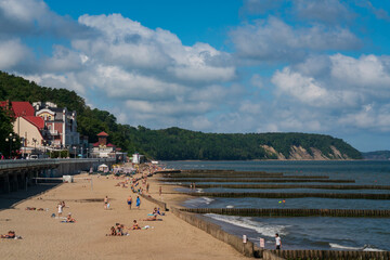 View of the promenade along the Baltic Sea coast and the city beach on a sunny summer day,...
