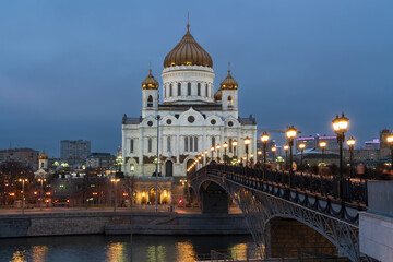 Fototapeta na wymiar View of the Cathedral of Christ the Savior and the Patriarchal Bridge from the Beresnevskaya embankment of the Moskva River at night, Moscow, Russia