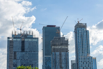 Fototapeta na wymiar Construction site skyscrapers cranes in cityscape.