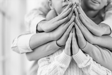 Family praying together at home, closeup - obrazy, fototapety, plakaty