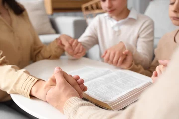 Foto op Plexiglas Family praying with Holy Bible on table at home, closeup © Pixel-Shot