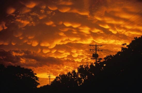 Orange, cumulonimbus mammatus clouds at sunset, looking west from Wichita. 