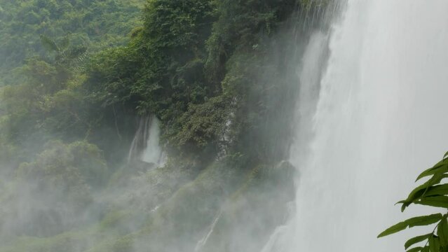 Steam vapor rising from waterfall creates mystical and ethereal atmosphere