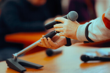 Hand Arranging a Microphone Preparing to Make a Speech. Spokesman making final arrangements before...