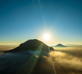 Aerial Elegance of a Butte Amidst the Evening’s Enchanting Fog