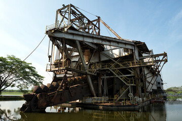 The last abandoned tin mining dredger during British colonial now display in Tanjung Tualang, Batu Gajah, Perak, Malaysia - obrazy, fototapety, plakaty