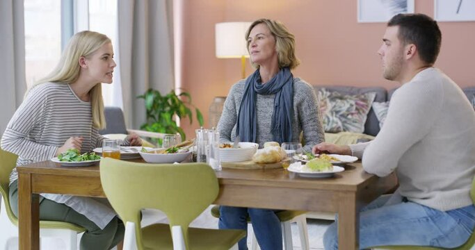 Frustrated mother, dining or siblings fight in living room dispute, argument or conflict at home. Mom in stress, anxiety or depression listening to brother, sister or bad disagreement at dinner table