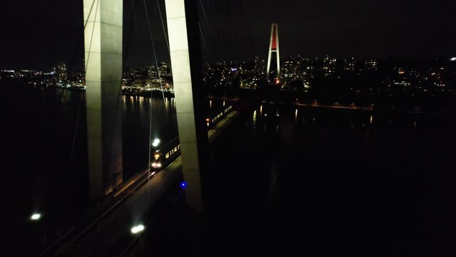 Aerial Footage During the Night. Vancouver, British Columbia, Canada. Aerial View of The SkyBridge is a Cable-Stayed Bridge for Sky Trains between New Westminster and Surrey.