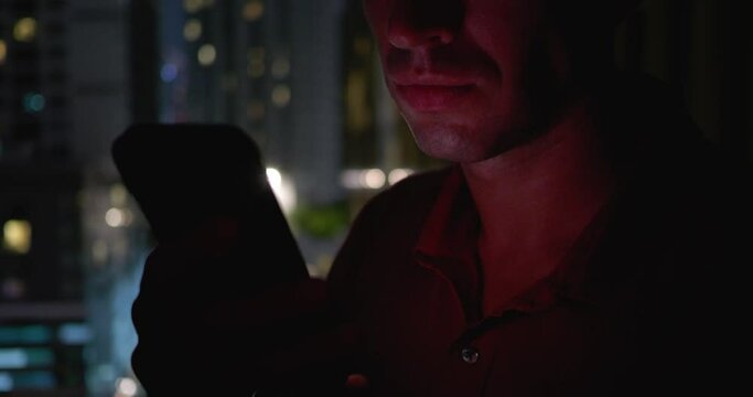 Night after night insomnia haunts man as he endlessly scrolls news Insomnia fed by anxiety of city life and digital overload. Man's insomnia keeps him trapped in cycle scrolling close-up view.