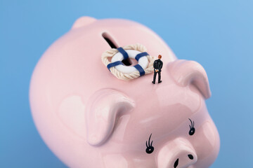 The merchant and the lifebuoy on the piggy bank in miniature