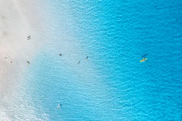 Deurstickers La Pelosa Strand, Sardinië, Italië Aerial view of amazing sea coast. Top view from drone of beach with white sand, swimming people in blue transparent water at sunny day. Summer in La Pelosa beach, Sardinia, Italy. Tropical landscape