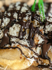 a fried banana dish topped with cheese and chocolate in the form of pasta