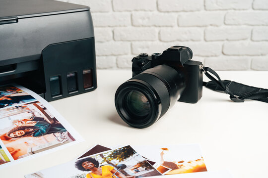 Printer and photo camera on table. Printing photos concept