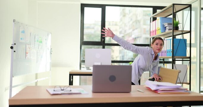 Businesswoman with phone clinging to chair and falling in office 4k movie slow motion