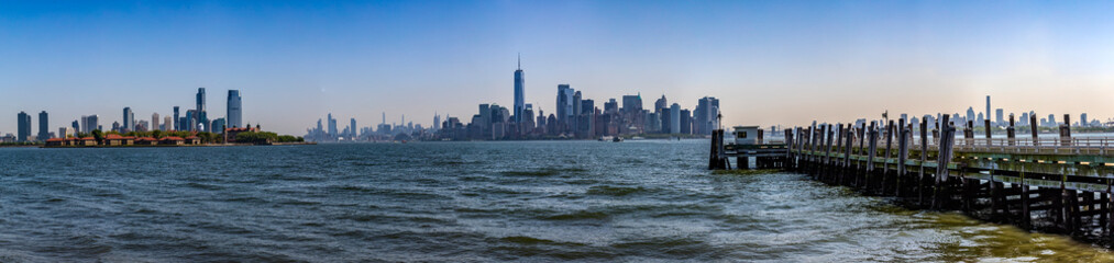 Panoramic view of Ellis Island and the New York Skyline under a beautiful blue sky, typical of the Big Apple and Manhattan. © Domingo Sáez