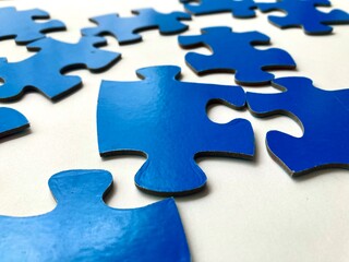 close up view of blue puzzle piece on white background
