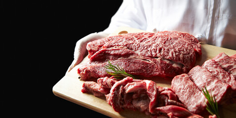 Several pieces of raw meat on a cutting board