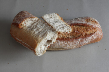 A broken freshly baked rustic baguette.