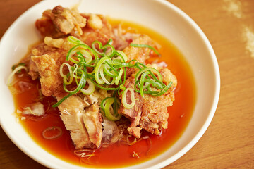 Fried chicken with green onion on a plate