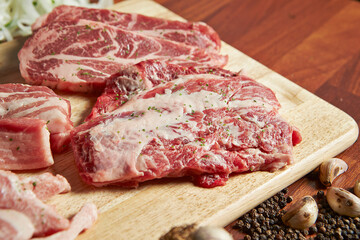 Raw meat on plate with various spices and vegetables	