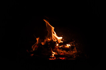 Fire flames on black background. Blazing campfire isolated on dark background.