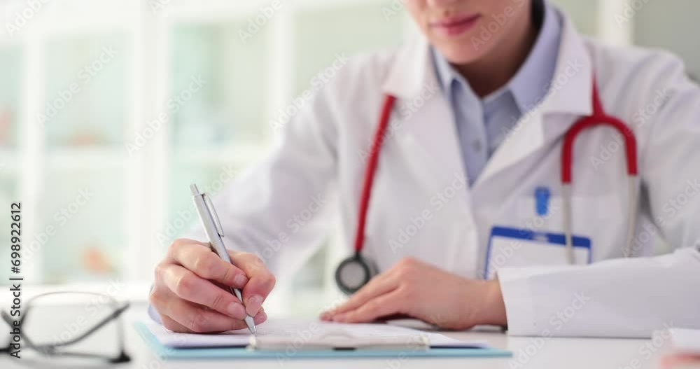 Wall mural doctor filling out medical documentation in clinic 4k movie slow motion