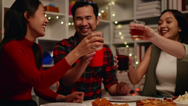 Friends join and celebrate the party with get cheers give a toast by clink glasses eating foods and drinks. Happy and joyful in holiday weekend and festival.