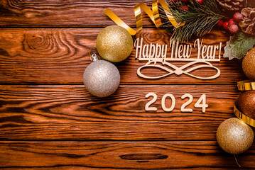 Happy new year 2024 on wooden brown background
