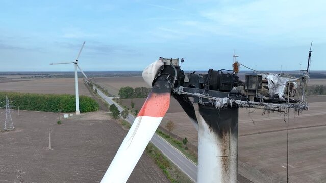Close-up of a burnt out wind turbine. Wind energy farm turbine destroyed, damaged by fire after a lightning strike. Windmill, energy production